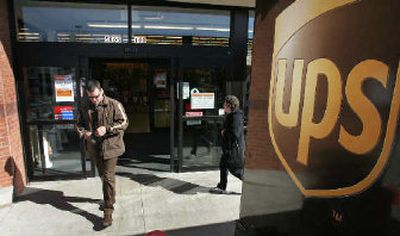 
United Parcel Service driver Joe Embleau makes his way back to his truck while making deliveries at a shopping center in Duluth, Ga., Thursday. UPS Inc., the world's largest carrier, reported today a rise in revenue with a 21 percent increase in fourth-quarter profit. 
 (Associated Press / The Spokesman-Review)
