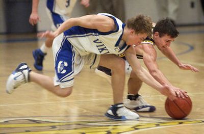 
Coeur d'Alene's Andrew Prohaska, left, and Lewiston's Shane Moser chase a loose ball at Coeur d'Alene High school Tuesday night. 
 (Tom Davenport/ / The Spokesman-Review)