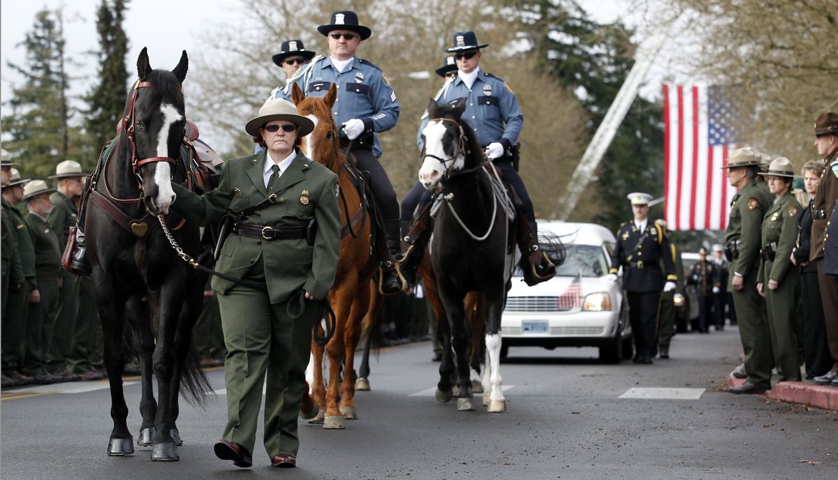 A riderless horse led by a ranger leads a procession to a memorial service for Mount Rainier National Park Ranger Margaret Anderson on Tuesday in Tacoma. (Associated Press)