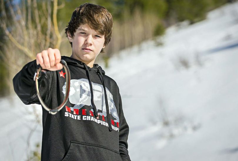 In this March 17, 2017 photo, Canyon Mansfield, 14, holds the collar of his dog, Casey, who was killed March 16 by a cyanide-ejecting device placed on public land near his Pocatello, Idaho, home by federal workers to kill coyotes. The cyanide device, called an M-44, is spring-activated and shoots poison that is meant to kill predators. The U.S. Department of Agriculture in November said it would not put the devices on public land in Idaho. (Jordon Beesley / Jordon Beesley/Idaho State Journal)
