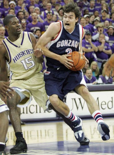 Gonzaga's Adam Morrison drives against Washington's Bobby Jones during the first half of Washington's win Sunday.
(Associated Press / The Spokesman-Review)