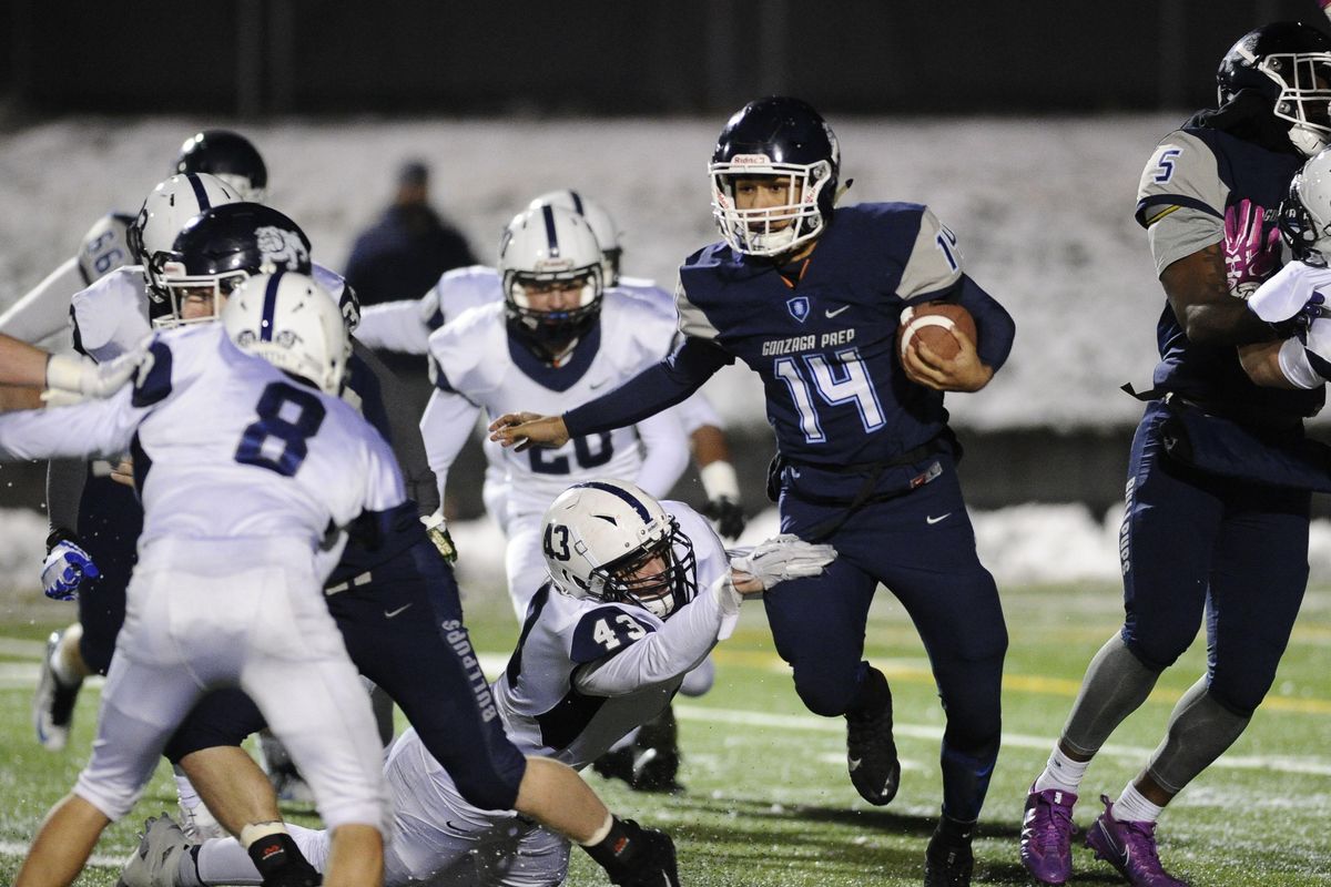 Gonzaga Prep Connor Halonen (14) breaks through the line against Chiawana Conrad Moore (43) on Friday, Nov. 3, 2017, at Gonzaga Prep High School. (James Snook / Special to The Spokesman-Review)