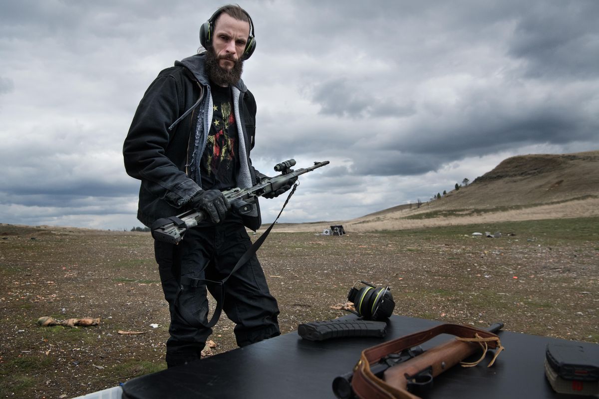 Republican candidate for Congress Jered Bonneau sets his rifle on a table after sending a few rounds down range during a target shoot meet-and-greet with supporters on Saturday, April. 14, 2018, near Fishtrap, Wash. (Tyler Tjomsland / The Spokesman-Review)