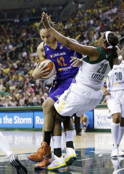 Seattle’s Camille Little draws charge on Phoenix’s Brittney Griner. (Associated Press)