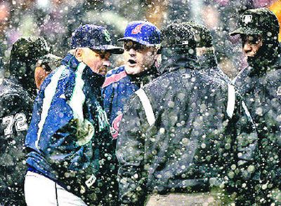 
Cleveland Indians manager Eric Wedge, center, argues with Seattle Mariners manager Mike Hargrove after Hargrove asked umpires to stop play in the top of the fifth inning of the game. 
 (Associated Press / The Spokesman-Review)
