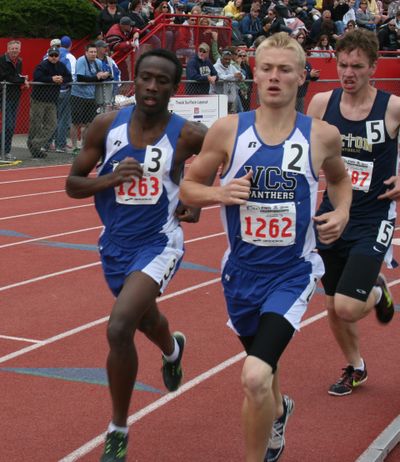 Richard Nyambura, left, and teammate Grant Marchant in the 3200 championship race Saturday at the state Class 1B track meet.