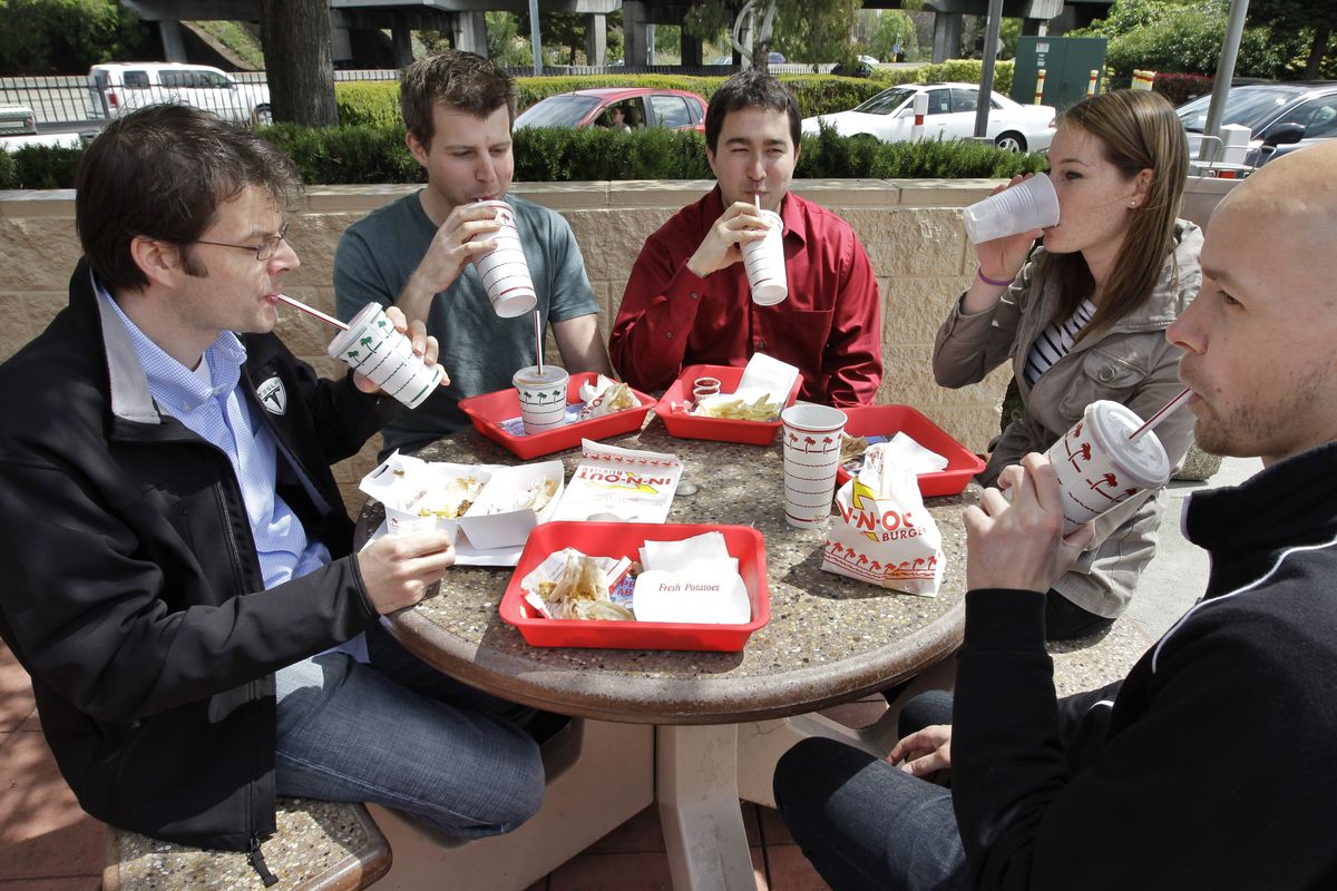 Tesla Motors workers take a lunch break together at In-N-Out Burger restaurant in Mountain View, Calif., on Thursday. In a case that affects thousands of businesses and millions of workers, the California Supreme Court ruled Thursday that employers in the state are under no obligation to ensure that workers take legally mandated lunch breaks. (Associated Press)