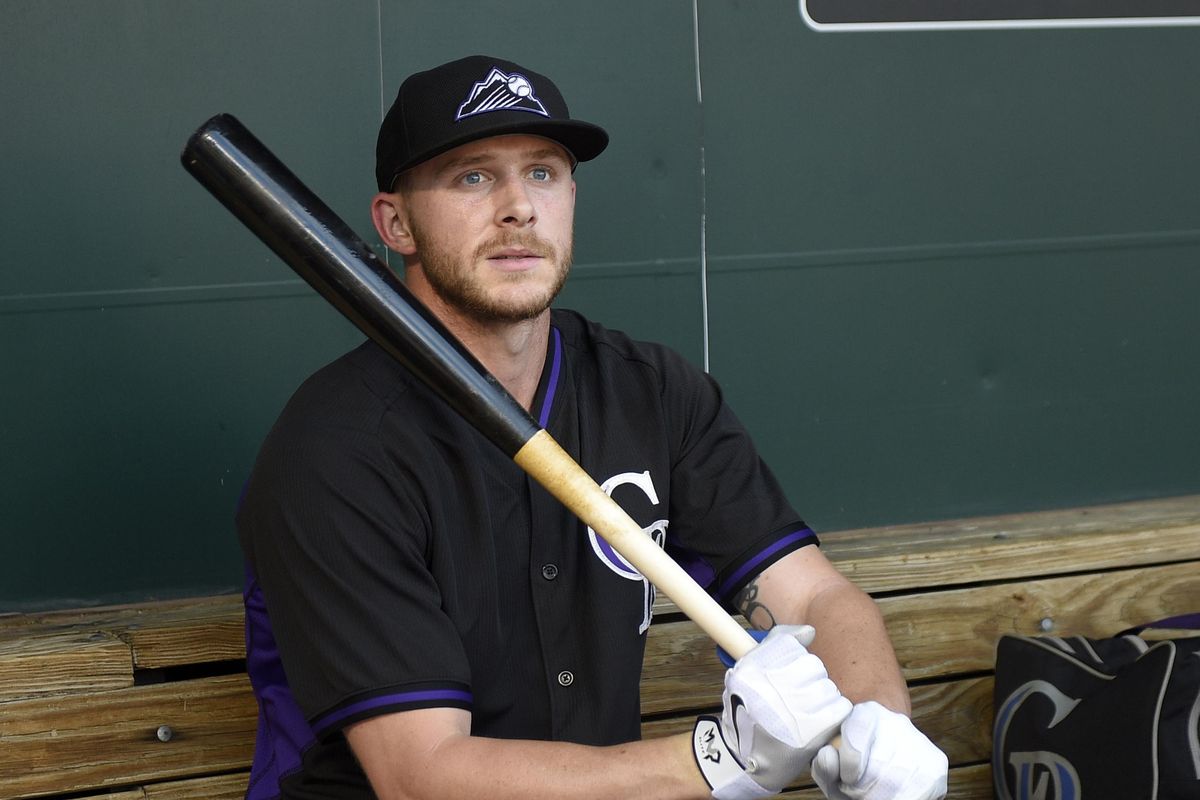 FILE - In this July 26, 2016, file photo, Colorado Rockies shortstop Trevor Story sits in the dugout during batting practice before the team