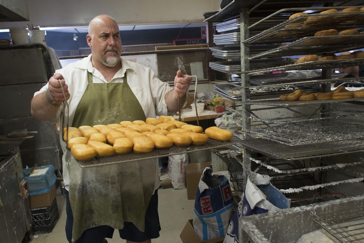 At the Donut Parade, owner Roy Reno makes a batch of maple bars on Friday, June 3, 2016. Reno says business has been down for the last six months and that they are going to have to raise prices to to be able to stay open. (Colin Mulvany / The Spokesman-Review)