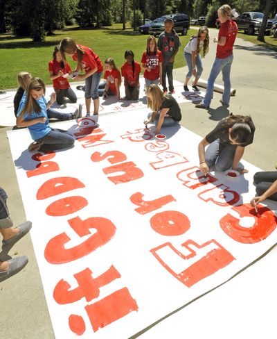 Kountze High School cheerleaders and others work on a banner for a football game last month. (Associated Press)