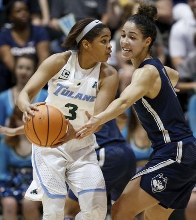 Connecticut guard Kia Nurse (11) reaches for the ball held by Tulane guard Kolby Morgan (3) during the first half of an NCAA college basketball game in New Orleans, Wednesday, Feb. 21, 2018. (Scott Threlkeld / Associated Press)