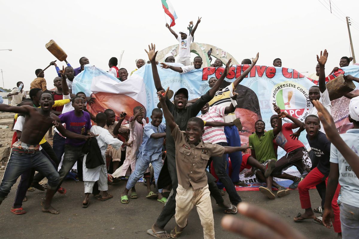 Residents celebrate the anticipated victory of Presidential candidate Muhammadu Buhari in Kaduna, Nigeria, on Tuesday. (Associated Press)