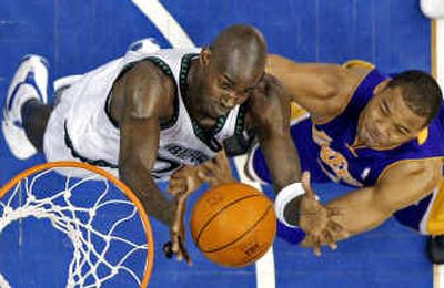 
Minnesota's Kevin Garnett, left, and the Lakers' Devean George go after a rebound in the first half Sunday in Minneapolis.Minnesota's Kevin Garnett, left, and the Lakers' Devean George go after a rebound in the first half Sunday in Minneapolis.
 (Associated PressAssociated Press / The Spokesman-Review)