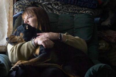 
Becca Itterman cuddles with her dog, Kodi,  in her north Spokane home. Itterman saved Kodi after finding the dog, severely beaten, in a trash can. Battling her own health problems, Itterman shares a support system with her dog, who helps her deal with her disabilities. 
 (Christopher Anderson / The Spokesman-Review)