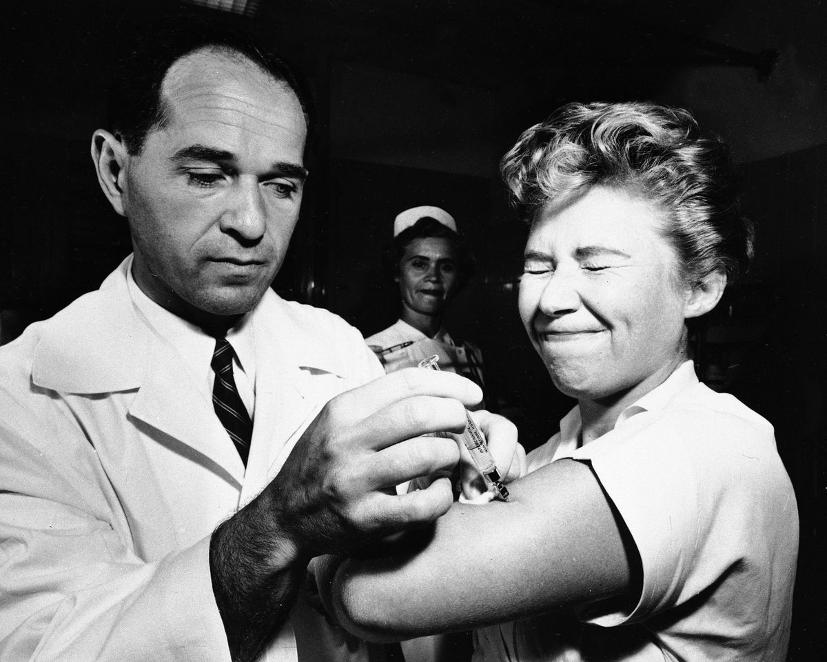 FILE - Dr. Joseph Ballinger giving Marjorie Hill, a nurse at Montefiore Hospital in New York, the first Asian flu vaccine shot to be administered in New York on Aug. 16, 1957.  (Anonymous)