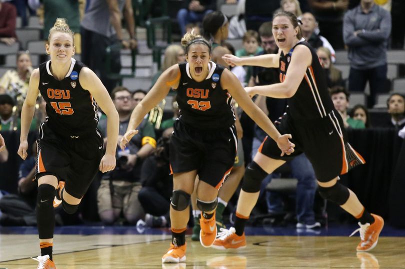 Oregon State guard Jamie Weisner (15) celebrates with teammates forwards Deven Hunter (32) and forward Ruth Hamblin (44) at the end Monday’s game. (LM Otero / Associated Press)