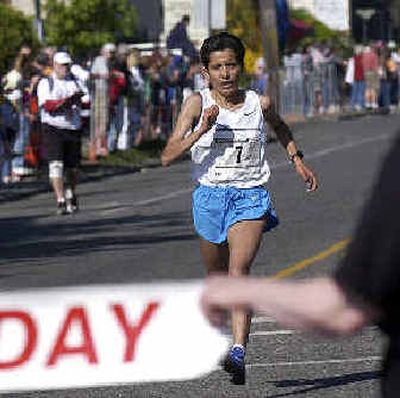 
Morocco's Asmae Leghzaoui crosses the finish line to win Bloomsday on Sunday morning.
 (Liz Kishimoto / The Spokesman-Review)