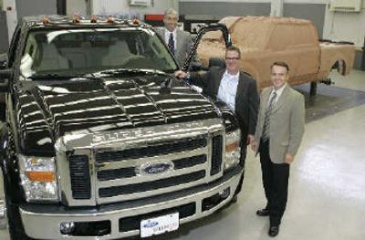 
Ford F-Series executives  stand next to a Ford F-450 truck in Dearborn, Mich. 
 (Associated Press / The Spokesman-Review)