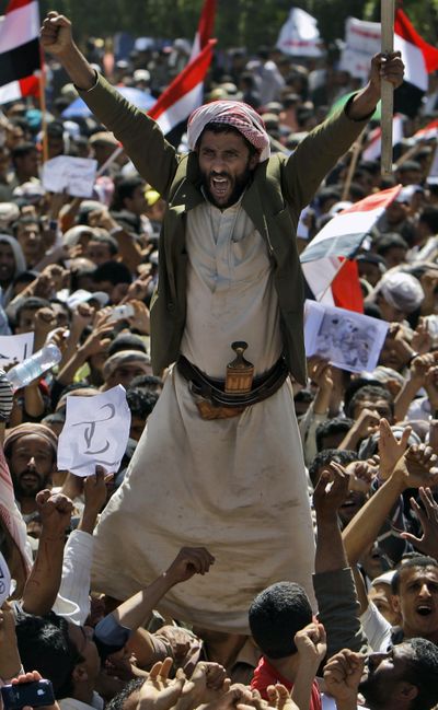 An anti-government protester and other demonstrators shout slogans demanding the resignation of Yemeni President Ali Abdullah Saleh in Sanaa, Yemen, Tuesday. (Associated Press)