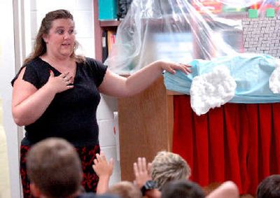 
Karen Yother, the children and youth services librarian at the Hayden branch of the Kootenai County Library, talks with a summer school class at Fernan Elementary before putting on a puppet show and passing out new books to the kids as part of the library's outreach programs. 
 (Jesse Tinsley / The Spokesman-Review)
