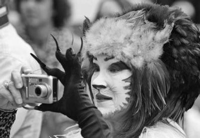 
Kristina Rochelle Steinke takes a picture during Mardi Gras celebrations in the French Quarter of New Orleans on Tuesday. 
 (Associated Press / The Spokesman-Review)
