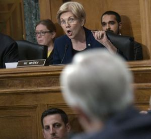 Senate Banking Committee member Sen. Elizabeth Warren, D-Mass., center, questions Wells Fargo CEO John Stumpf, foreground, on Capitol Hill in Washington, Tuesday, Sept. 20, 2016, during the committee's hearing. Stumpf was called before the committee for betraying customers' trust in a scandal over allegations that employees opened millions of unauthorized accounts to meet aggressive sales targets. (Susan Walsh / AP)