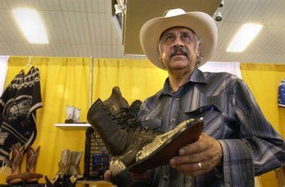 
Fernando Sanchez, a custom bootmaker and owner of La Tiendita,  shows his boots and other goods at La Fiesta, an annual Cinco de Mayo celebration in Post Falls on Saturday. 
 (Jesse Tinsley / The Spokesman-Review)