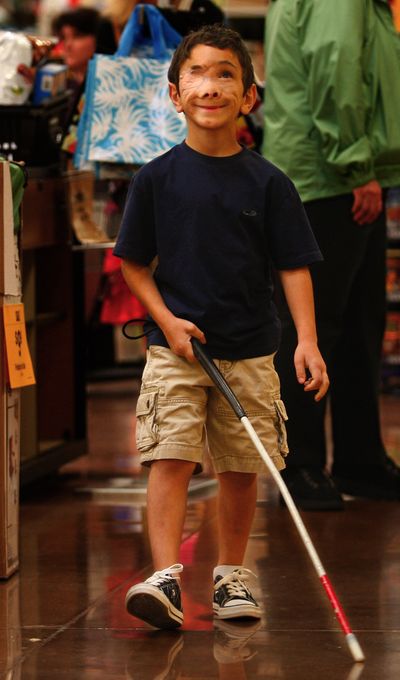 Muhammed “Hamoody” Jauda smiles as he sets off to find the toy section at the Fred Meyer store in Snohomish, Wash., on June 17.  He is receiving a lesson on how to navigate in a store by himself.  (Associated Press)