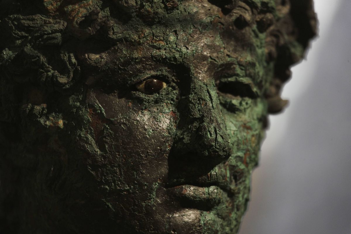 A Dionysus bust is displayed at the museum Antiquarium, in Pompeii, southern Italy, Monday, Jan. 25, 2021. Decades after suffering bombing and earthquake damage, Pompeii