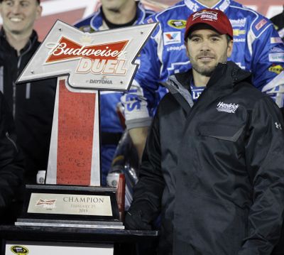 Jimmie Johnson displays the trophy for taking the second of two qualifying races. (Associated Press)