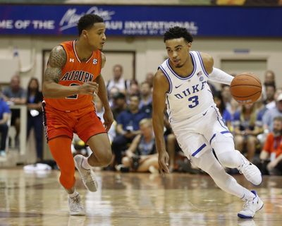 Duke guard Tre Jones  tries to dribble around Auburn guard Bryce Brown  during the first half Tuesday at  the Maui Invitational  in Lahaina, Hawaii. (Marco Garcia / AP)