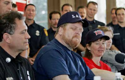 
John Phipps is momentarily overcome as he talks about how he was rescued from a derailed train.
 (Associated Press / The Spokesman-Review)