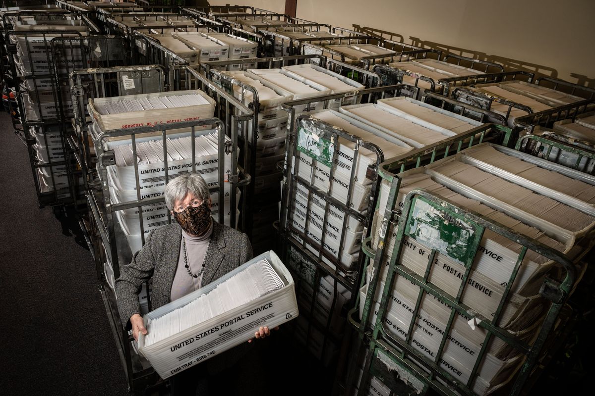 At the Spokane County Elections Office in 2020, Spokane County Auditor Vicky Dalton holds a bin of ballots, which are part of the 340,000 ballots that will be mailed out to registered voters.  (COLIN MULVANY/THE SPOKESMAN-REVIEW)