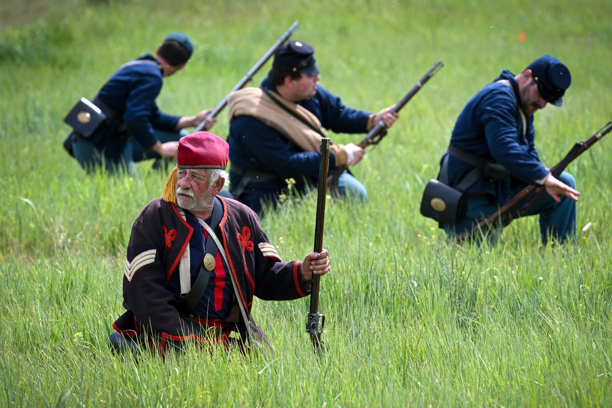 Don Saia, in the stylish uniform of the 5th New York Infantry Regiment, fights alongside conventionally dressed Union troops Monday in a farmer’s field during the final battle of the Opening Skirmish at Creston Crossing on Monday near Wilbur, Wash. The Civil War re-enactment event spread over the Memorial Day weekend. The uniform of the New York infantry was inspired by the French Foreign Legion. (Jesse Tinsley/THE SPOKESMAN-REVIEW)