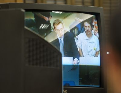 Robert Ruth, who is accused of helping Charles Wallace, is seen on a closed-circuit courtroom television in June in Spokane County Superior Court. (Tyler Tjomsland)