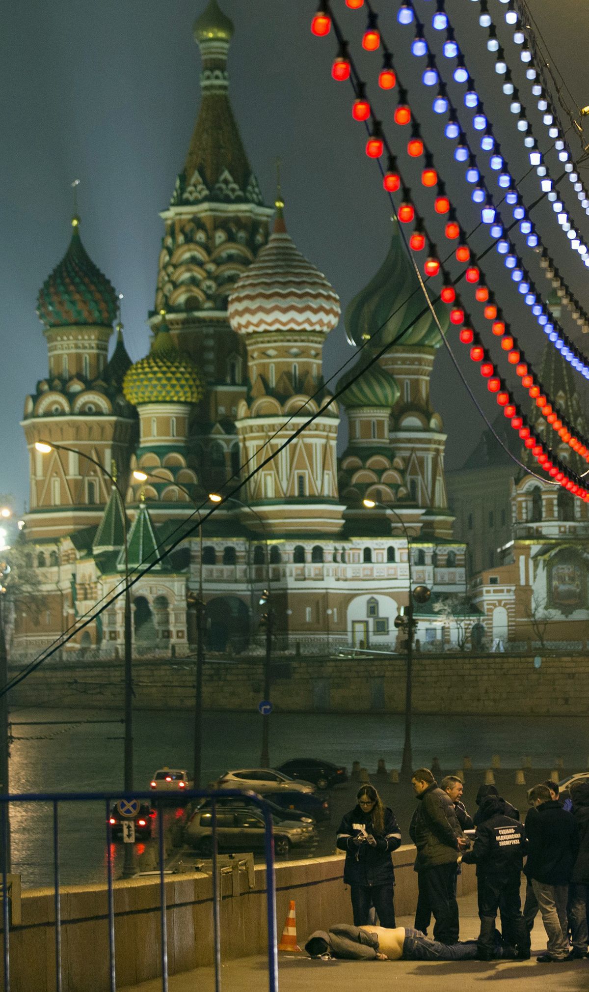 Police investigate the area next to the body of Boris Nemtsov, an opposition leader and a former deputy prime minister, at Red Square in Moscow today. In the background is St. Basil