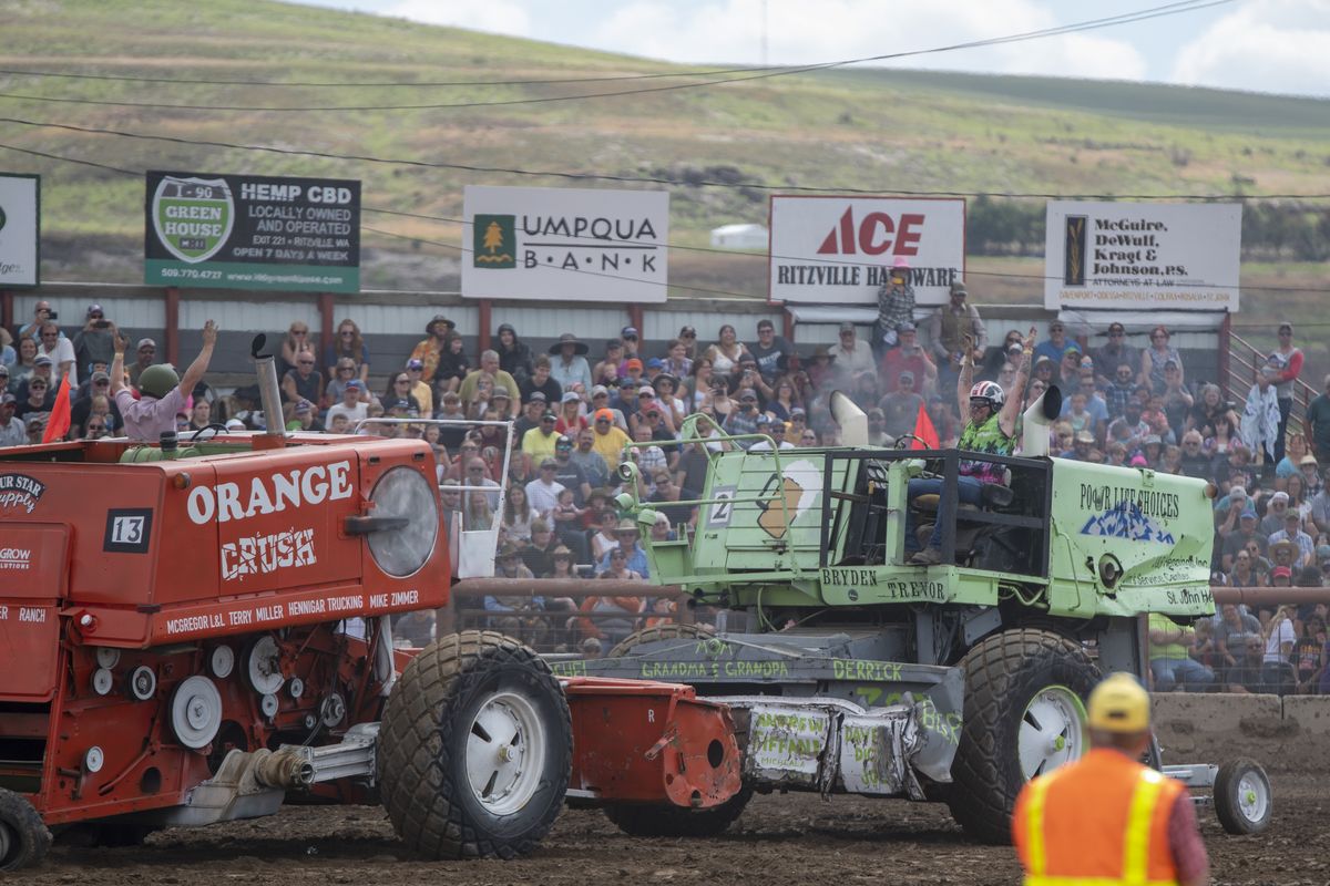 Lind Combine Derby drivers Caleb Hannahs, left, and Bryden Laird throw up their hands as their slow-moving vehicles lurch into each other with a screech of metal and revving diesel engins Saturday, June 10, 2023 in Lind, Washington. The longtime annual event, which is a major fundraiser for the town