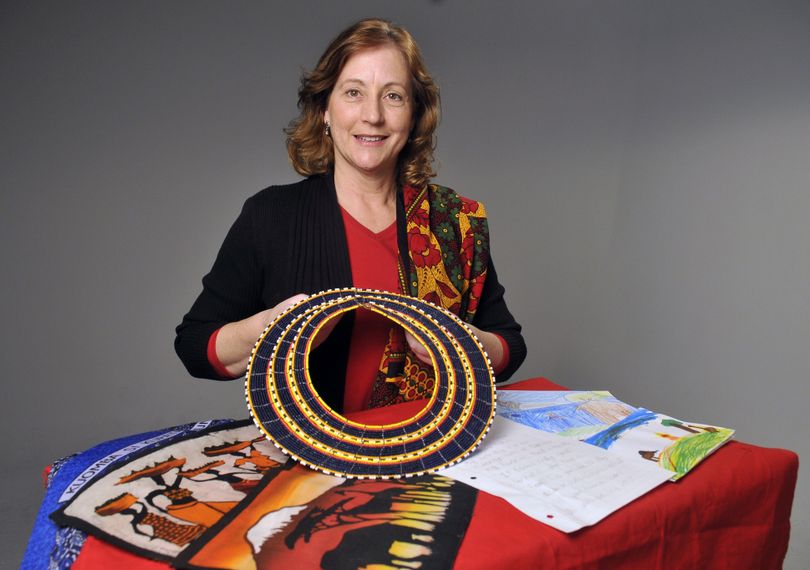 Ann Teberg, of Whitworth University, displays her African hand crafts, including a Maasai beaded necklace she was given after visiting St. Margaret's Academy in Arusha, Tanzania. She has taken a leave of absence from teaching to live in Arusha for three months. The cards, letters and drawing, seen at right, are from Colton Elementary School students will who be pen pals to the children of St. Margaret's. (Jesse Tinsley / The Spokesman-Review)