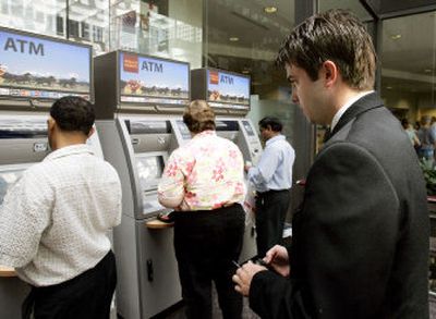 
Jay Gustafson waits to use a Wells Fargo ATM in Minneapolis. Gustafson paid $5 to withdraw $20. 
 (Associated Press / The Spokesman-Review)