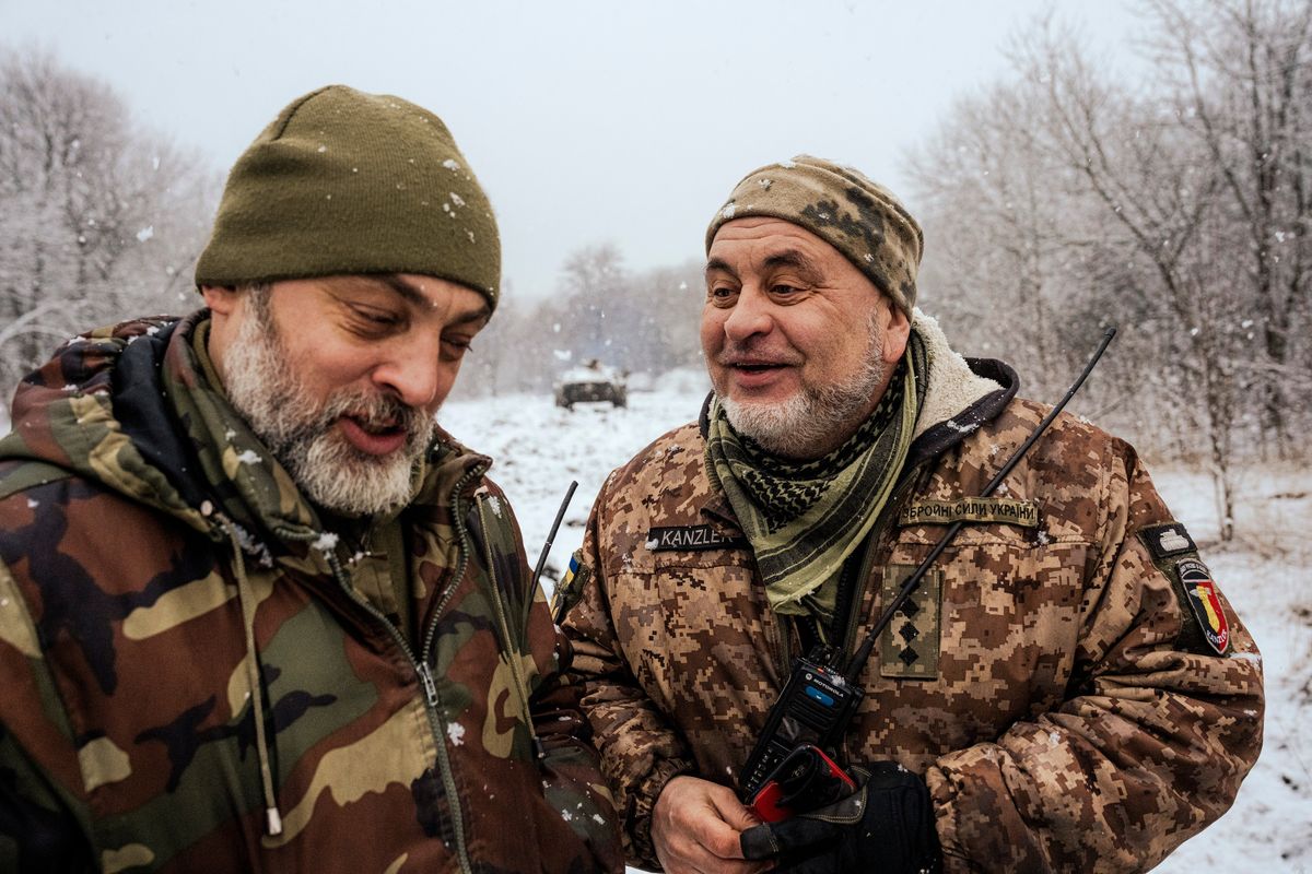 The tank commander Poltava, left, and his deputy, Chancellor, preparing to head toward the front line near Bakhmut, Ukraine on March 7, 2023. While both were trained in tank warfare, they left their military careers in the early 1990s, only to resume them in the current war.    (Daniel Berehulak/The New York Times)