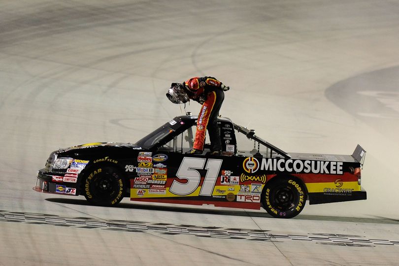 Kyle Busch, driver of the No. 51 Miccosukee Resort/Graceway Pharmaceuticals Toyota, bows to the crowd at the start/finish line after winning the NASCAR Camping World Truck Series O'Reilly 200 at Bristol Motor Speedway on Wednesday in Bristol, Tenn. (Photo Credit: John Harrelson/Getty Images for NASCAR)  (John Harrelson / The Spokesman-Review)