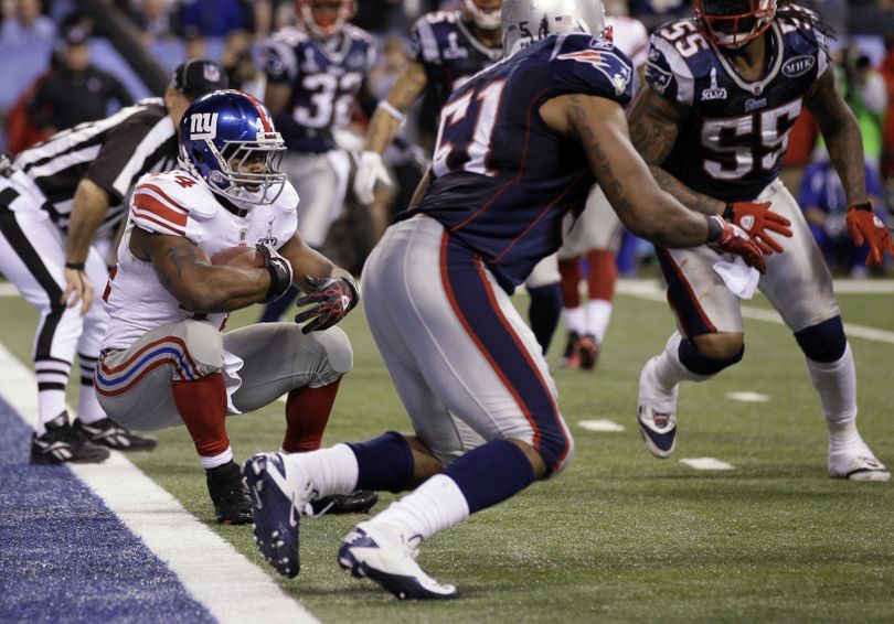 New York Giants running back Ahmad Bradshaw (44) rolls into the end zone for a touchdown during the second half of the NFL Super Bowl XLVI football game against the New England Patriots, Sunday, Feb. 5, 2012, in Indianapolis. (Mark Humphrey / Associated Press)