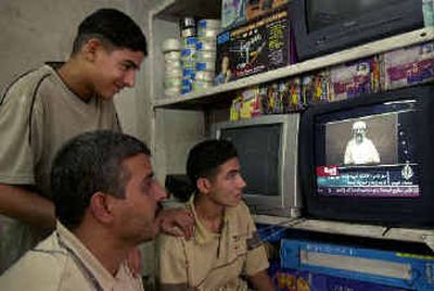 
A shop owner and his workers watch Osama bin Laden speak on an Al-Jazeera newscast in Baghdad, Iraq, on Saturday. 
 (Associated Press / The Spokesman-Review)