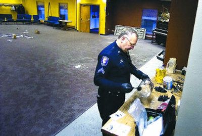 
Spokane police Cpl. Jon Strickland dusts for fingerprints Thursday after vandals trashed the Garland Avenue Alliance Church.
 (Photos by Christopher Anderson / The Spokesman-Review)