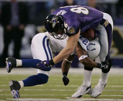
Indianapolis cornerback goes low for the tackle on Baltimore tight end Todd Heap on Saturday in a AFC divisional playoff game.
 (Associated Press / The Spokesman-Review)