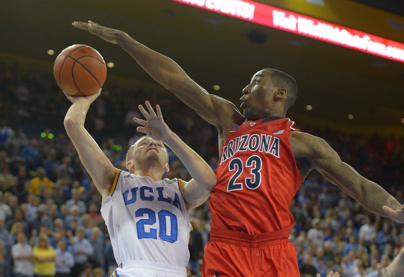 UCLA’s Bryce Alford, left, shoots as Arizona’s Rondae Hollis-Jefferson defends. (Associated Press)