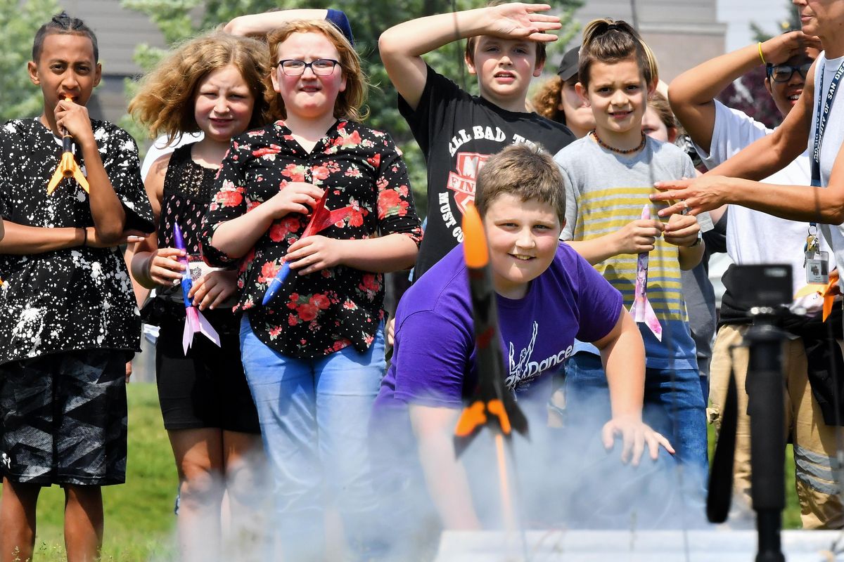 Michael Fortner reacts as he launches his rocket, Hunter, with classmates on Tuesday  at Andrew Rypien Field in Spokane. The rocket launch was part of a STEM rocket program at Garfield Elementary School that is sponsored by The Rotary Club. (Tyler Tjomsland / The Spokesman-Review)