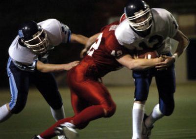 
Gonzaga Prep quarterback Max Manix, right, tries to shake Pat Parham of Ferris during Friday night's game at Joe Albi Stadium. Manix ran for two touchdowns.
 (Holly Pickett / The Spokesman-Review)