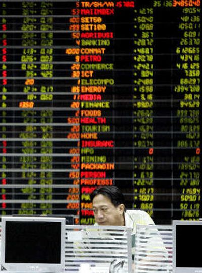
A Thai investor monitors stock prices at a private stock trading floor Wednesday in Bangkok, Thailand. Thailand's stock market opened nearly 9 percent higher Wednesday, recovering from a historic fall that shook regional markets and sparked concerns over another Asian financial crisis. 
 (Associated Press / The Spokesman-Review)