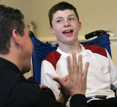 
Steven Domalewski tries to high five with his father Joseph at their home in Wayne, N.J. Associated Press
 (Associated Press / The Spokesman-Review)